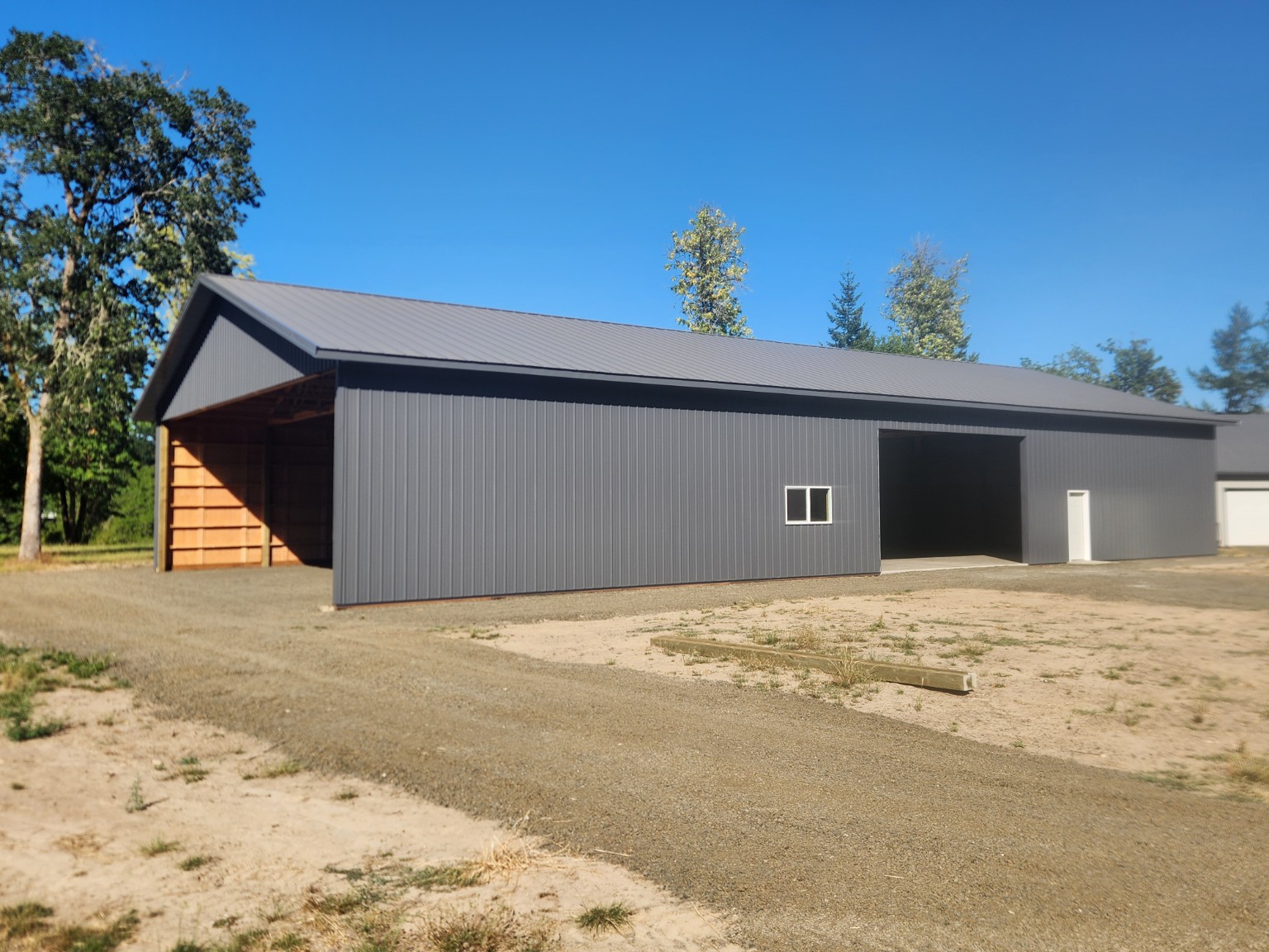 Gravel site preparation around a completed post-frame shop